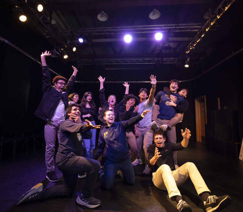 students pose together in a theater arts class