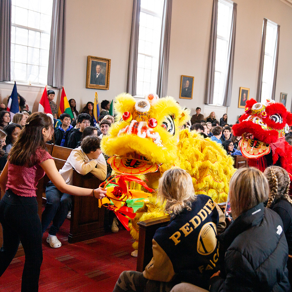 Students perform lion dance in chapel