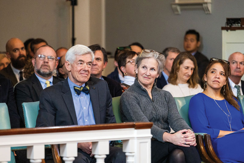 Head of School Peter Quinn and others listen to former Head of School John Green's Founders Day speech in spring 2024.