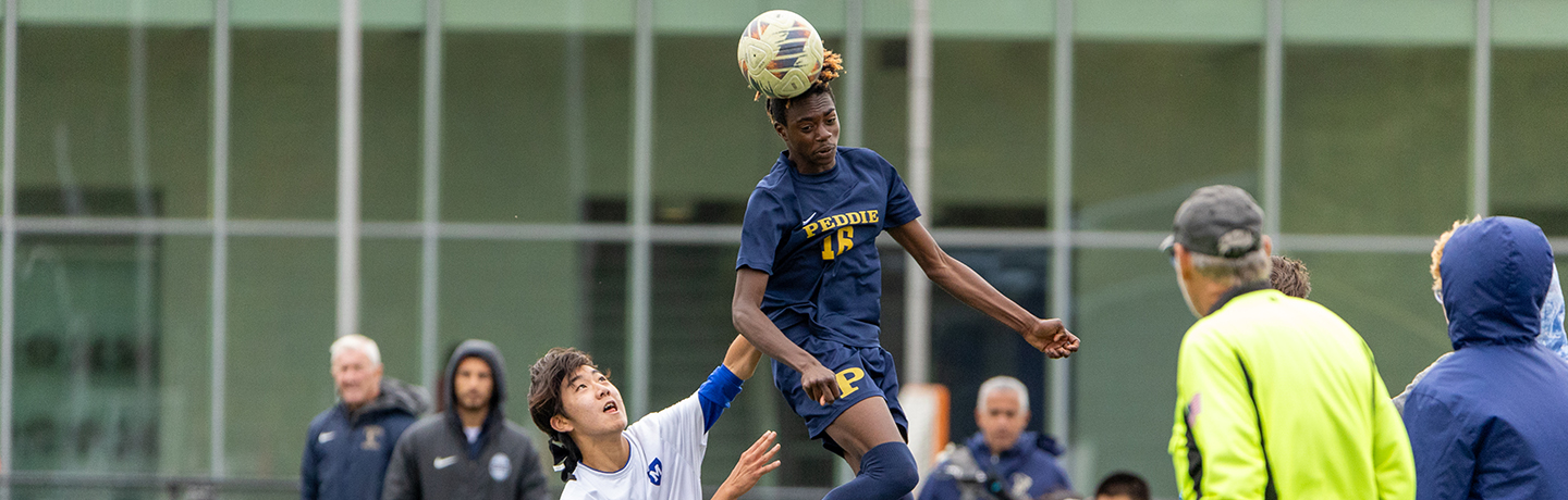 A Soccer Player Directs A Header