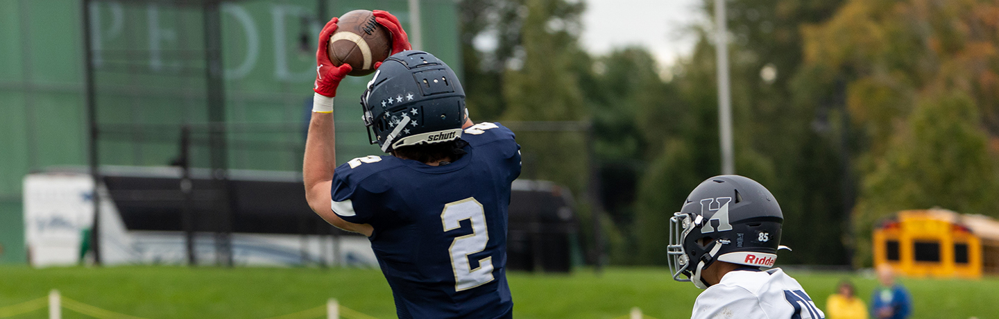 A Football Player Catches The Pass