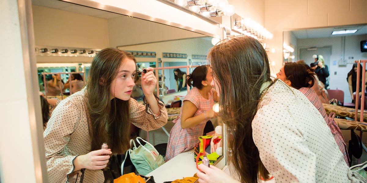 female student getting ready for the play