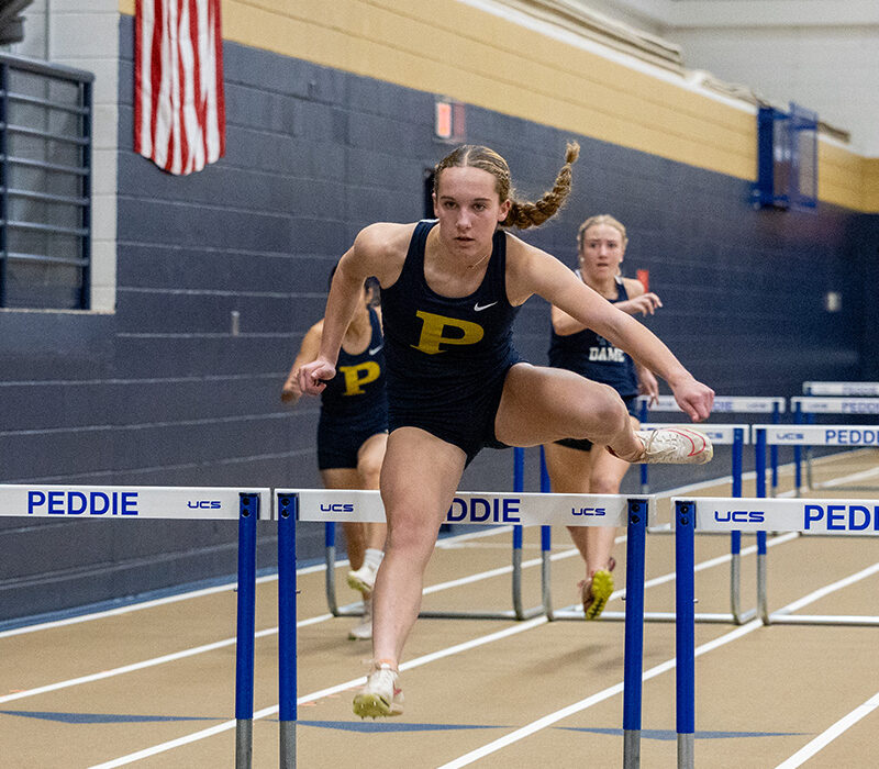 Tessa Hughes Jumps Over Hurdles