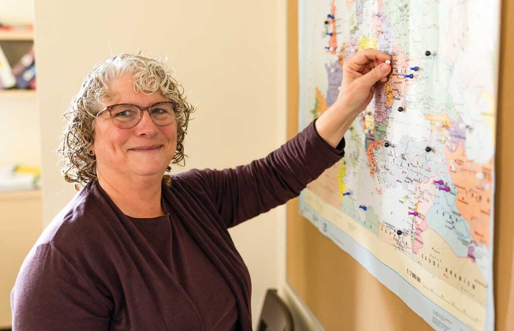 History teacher Lynn Berrettoni highlights a historical event with a pin on a map while discussing European history in her classroom. During her 20-year tenure, Berrettoni helped reshape Peddie’s history curriculum to reflect a more global perspective.