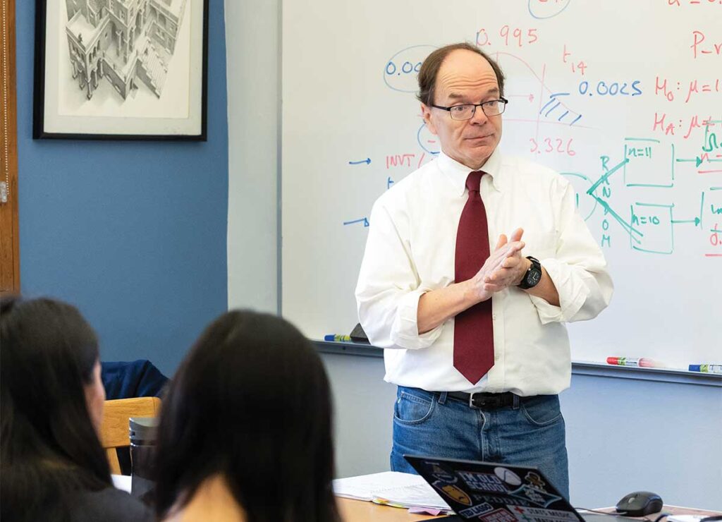 Math teacher Andrew Caglieris works with students in his classroom. Since 2005, Caglieris has played a key role in evolving the department, mentoring colleagues and introducing innovative, evidence-backed courses.