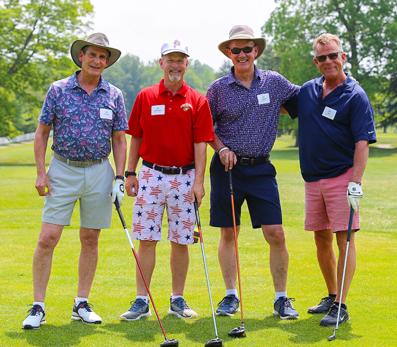 golfers pose together at alumni weekend