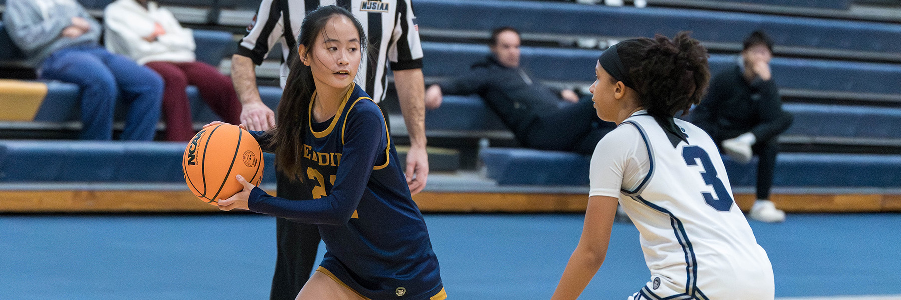 Minh Le dribbles the basketball for Peddie varsity girls basketball