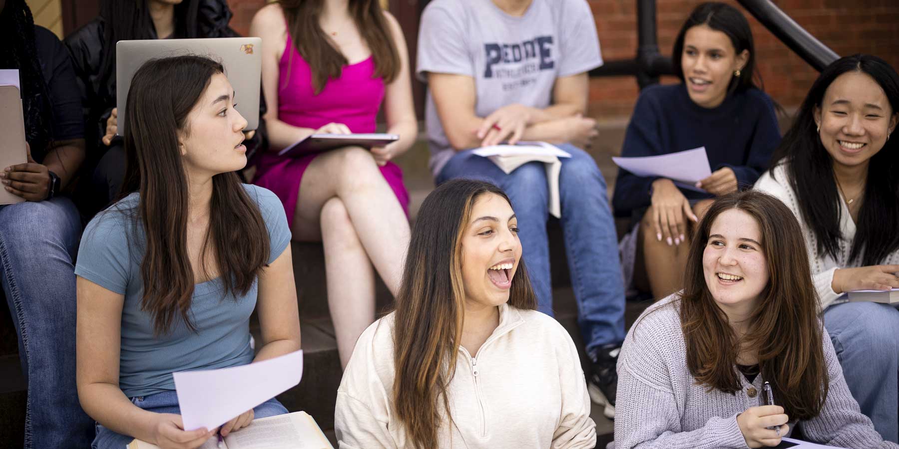 Peddie students learning outside on the steps of Longstreet Hall