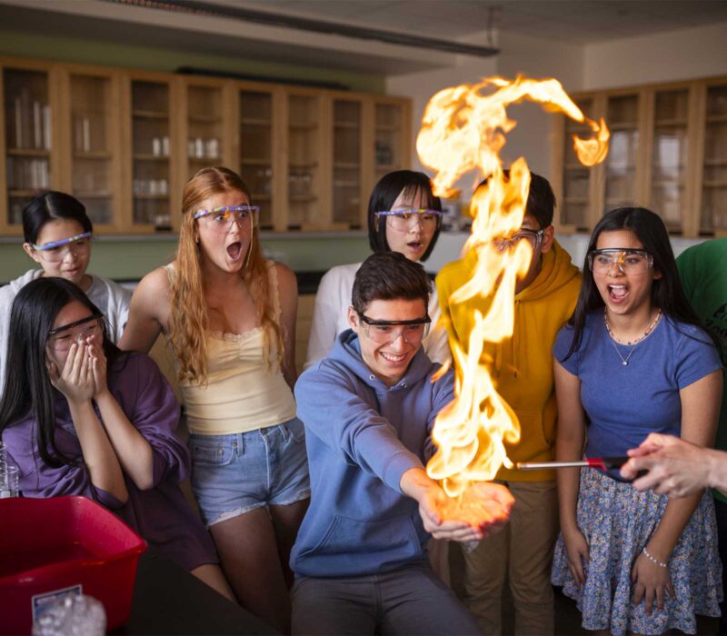 Student holds a fireball in a Peddie Chemistry lab experiment.