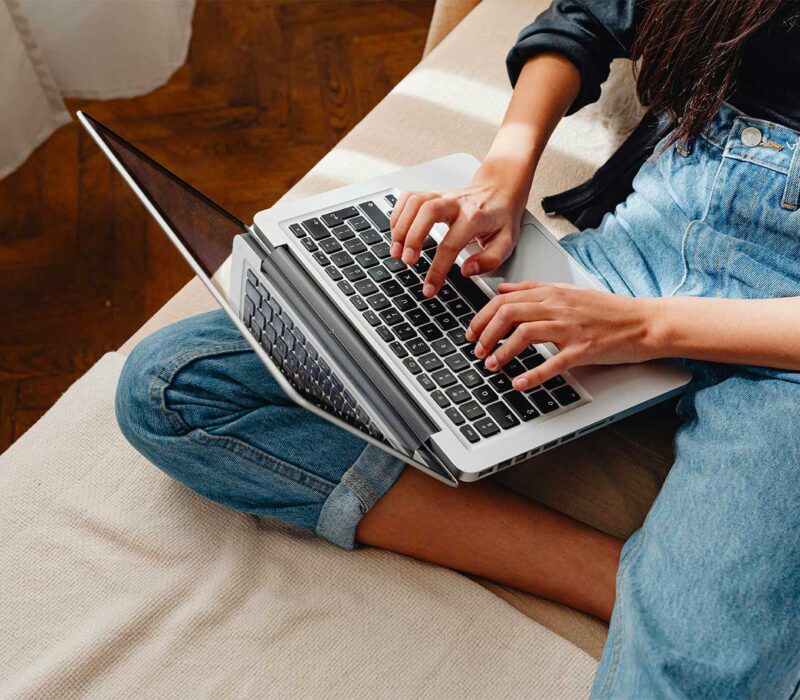 Student writing an essay on a laptop