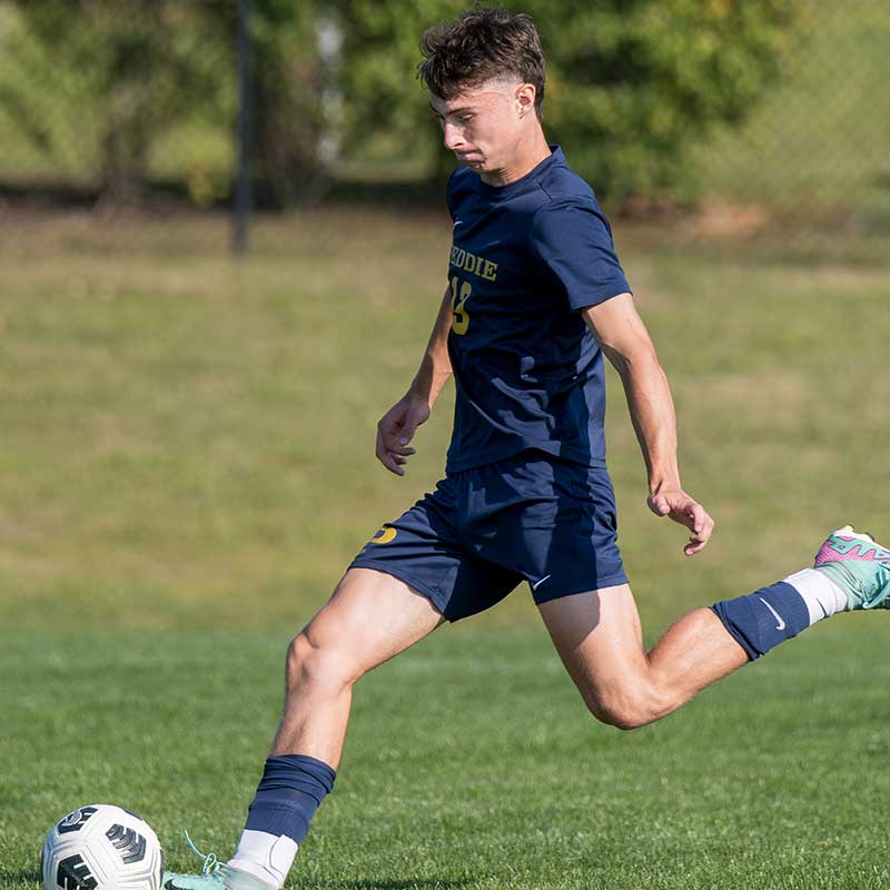 Christian Tharney strikes the soccer ball. 